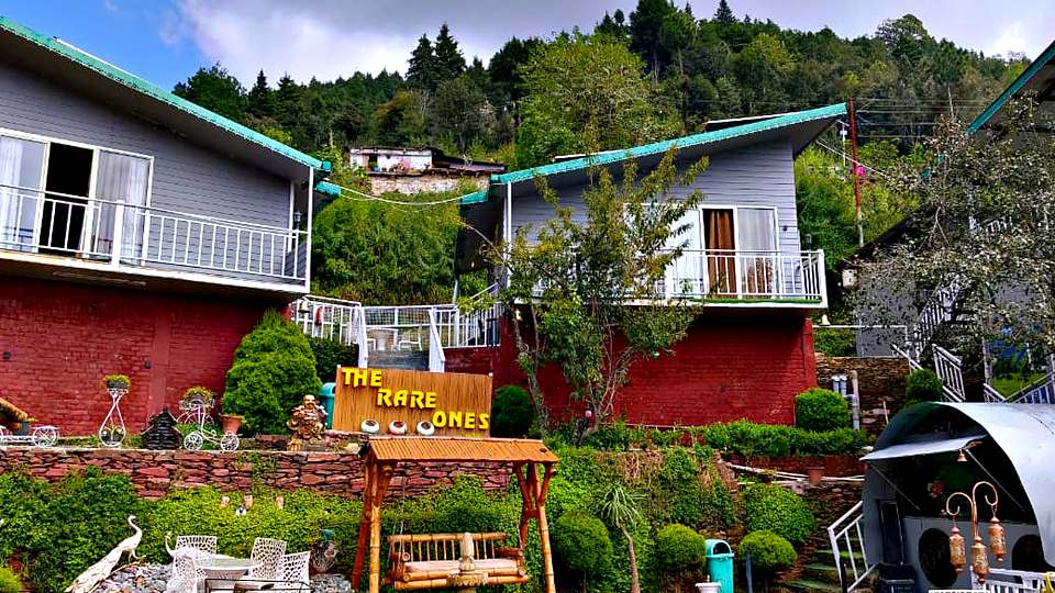 Garden and signboard at the entrance of The Rare One’s Resort, Mukteshwar