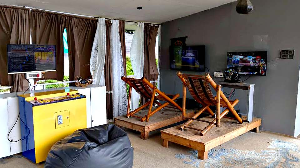 Gaming lounge with racing simulators and bean bags at The Rare One’s Resort, Mukteshwar