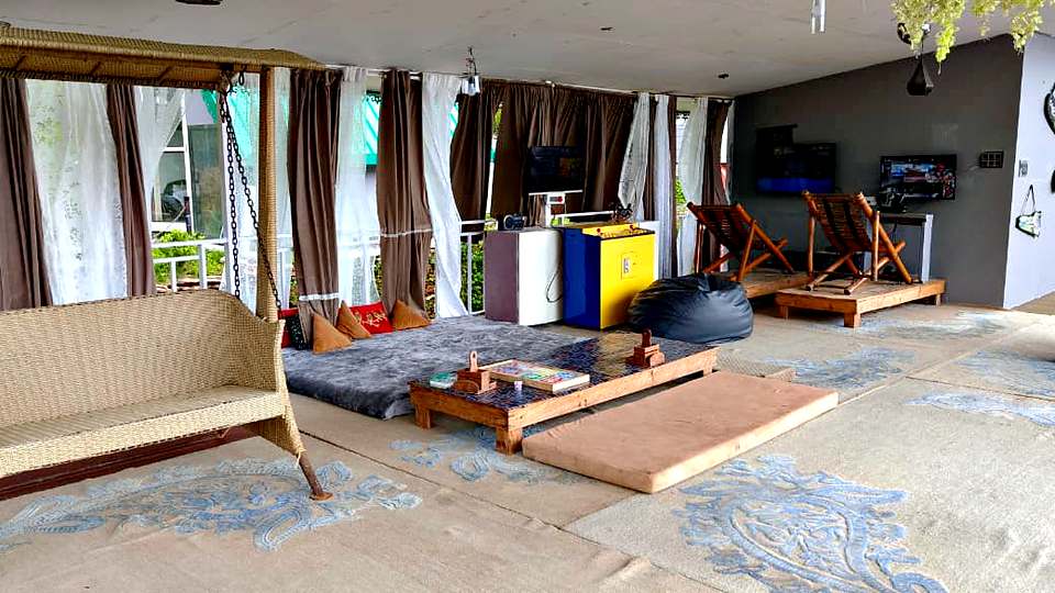 Indoor lounge with floor seating and games at The Rare One’s Resort, Mukteshwar